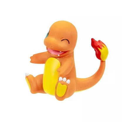 A Charmander toy figurine sitting down, featuring its signature orange body, yellow belly, and red and yellow flame tail on a plain white background.