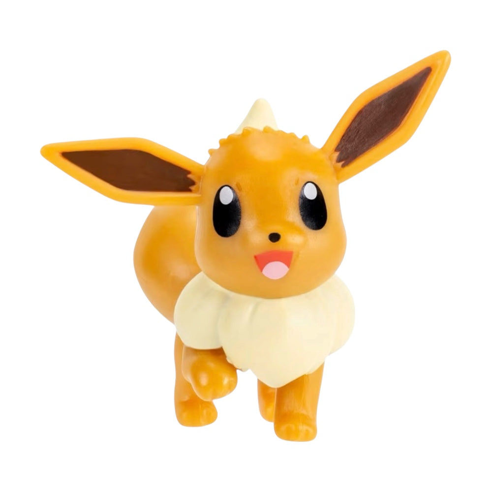 A small plastic figurine of Eevee, a yellow-orange cartoon creature with large black eyes, a cream-colored ruff around its neck, and brown inner ears, shown on a plain white background.