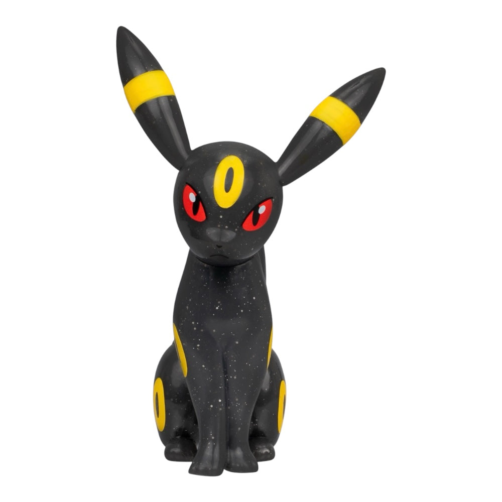 A collectible figurine of Umbreon, a black Pokémon with yellow stripes on its ears and yellow markings on its body, featuring red eyes, set against a plain white background.
