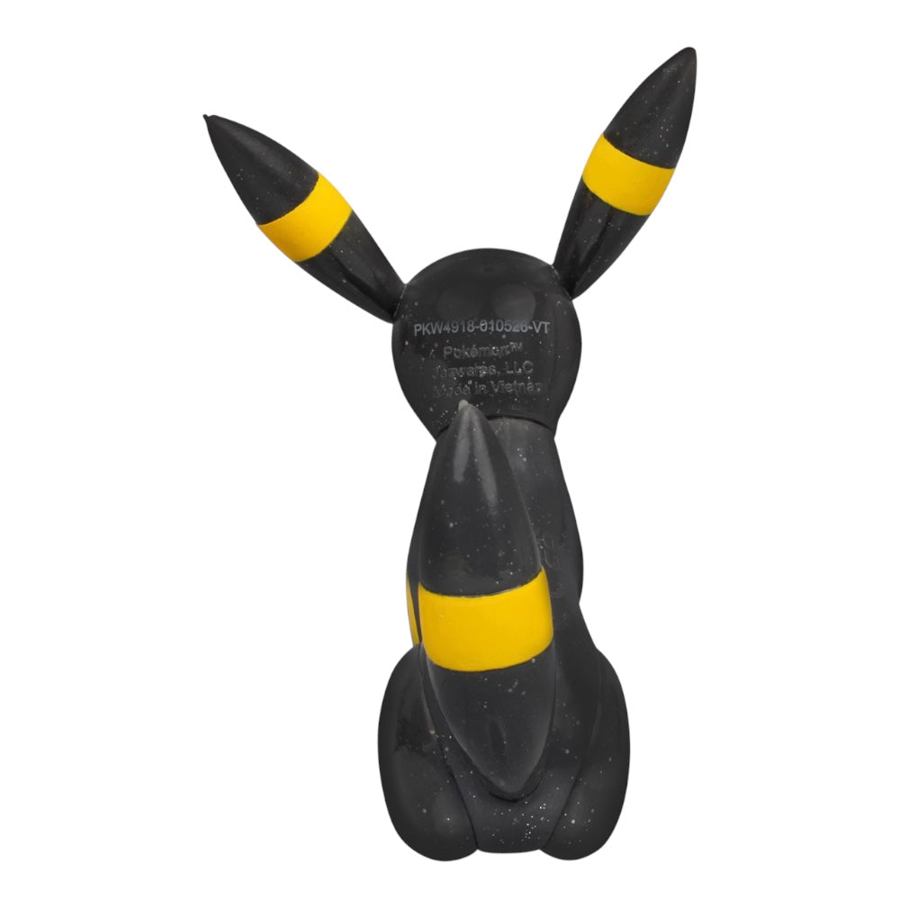 A black and yellow Pikachu figurine shown from the back, featuring its signature yellow stripes on the ears and back, on a solid white background.