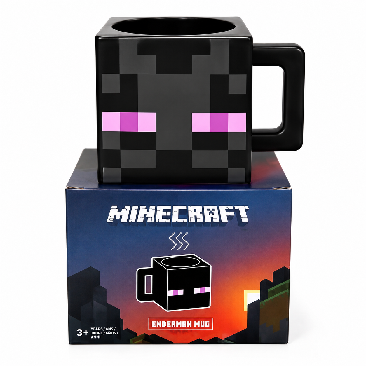 A black Minecraft Enderman mug with pixelated pink eyes, displayed on top of its blue and orange branded product box against a white background.