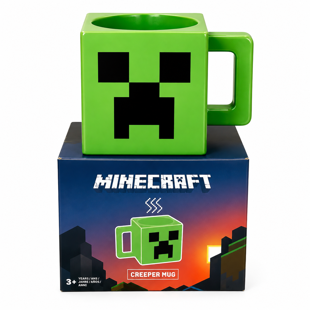 A green Creeper-themed ceramic mug with a pixelated face, displayed on top of its blue Minecraft retail box against a white background.