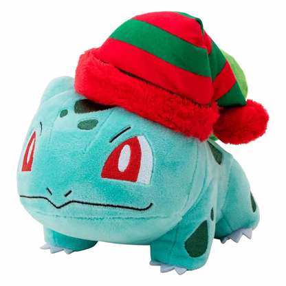 A plush toy of Bulbasaur wearing a festive red and green striped knit hat with a fluffy trim and pom-pom, set against a plain white background.