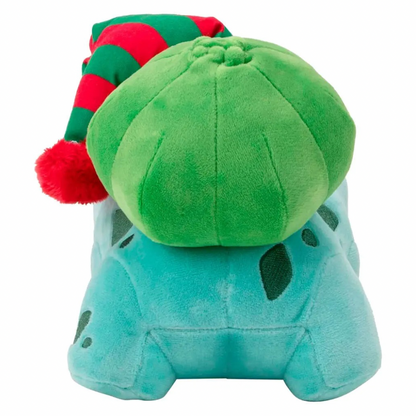 A plush toy shaped like a blue-green creature with a large green dome on top, wearing a red and green striped elf hat with a red pom-pom, shown on a plain white background.